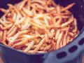 Goldbraune, knusprige Pommes im Airfryer, bereit zum Genießen.
