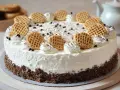 Cremige Mohrenkopftorte mit Keksboden, verziert mit Sahnetuffs, Schokostreuseln und kleinen Waffeln. Ein Traum für jeden Kaffeetisch!