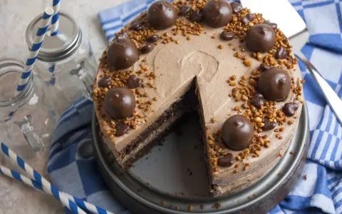 Schokoladige nougat torte mit Pralinen und Nüssen, bereit zum Genießen.