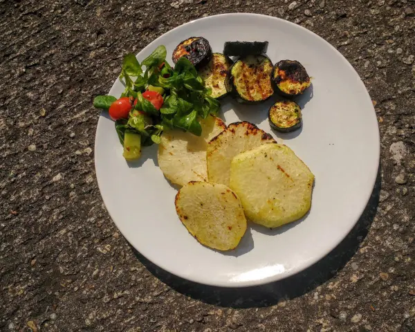 Gegrillte Kohlrabi-Scheiben mit Zucchini und einem kleinen Salat. Ein leckeres Gericht, das Lust auf Kohlrabi grillen macht.