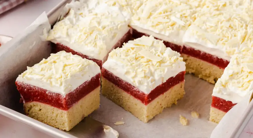 Schichtkuchen mit roter Fruchtschicht, weißer Creme und Schokostreuseln – perfekt als Kuchen zum Muttertag.