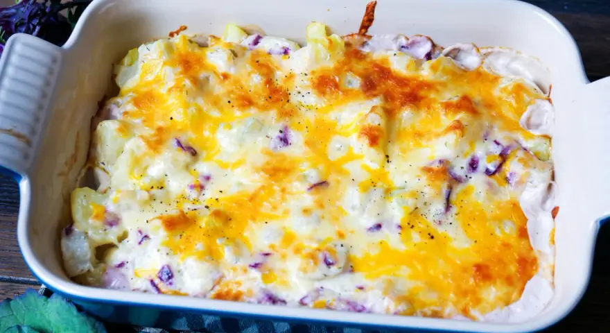 Kohlrabi Kartoffel Auflauf mit geschmolzenem Käse in einer Auflaufform, bereit zum Servieren.